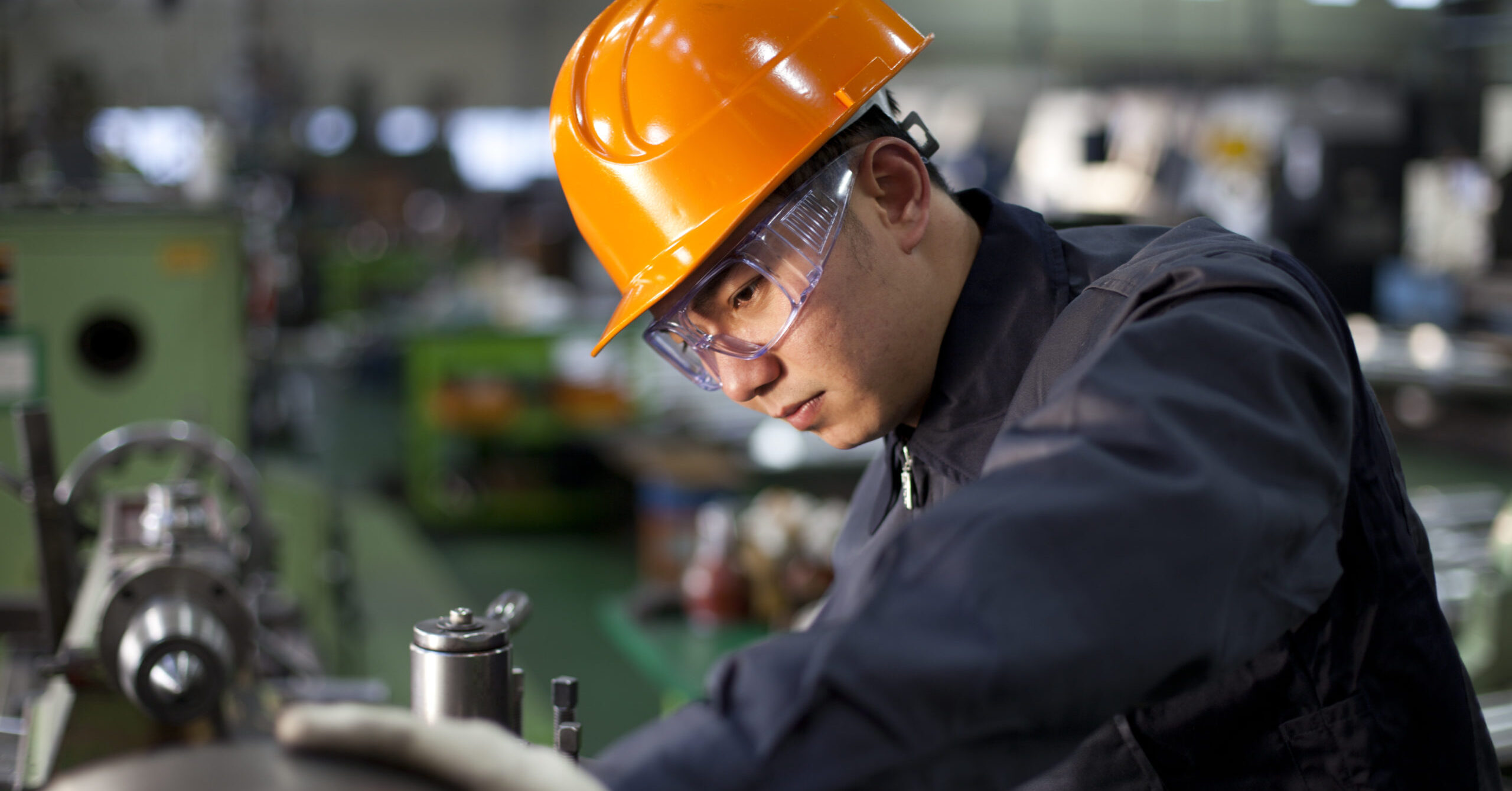 An employee looks over machinery