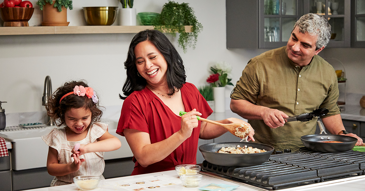 A family cooks a meal together using HelloFresh